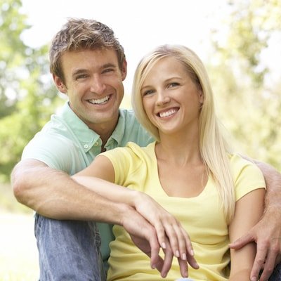Smiling couple show how Invisalign® by East Orlando Cosmetic Dentist Dr. Morales straightens your smile